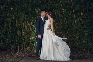 intimate summer elopement, Rothko chapel, Houston intimate elopement, Texas intimate elopement photographer, navy blue suit, sleeveless wedding dress, summer wedding, greenery, bride and groom, just married