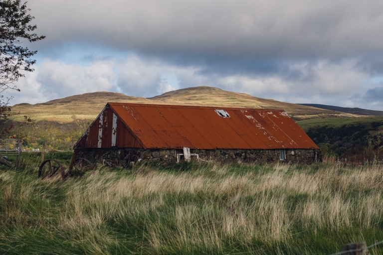 red roof barn in tall grass on the isle of skye