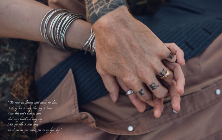 tattooed couple holding hands