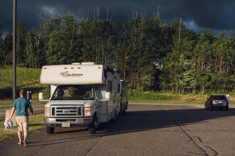 man walking to a coachman RV in a hospital parking lot in michigan 